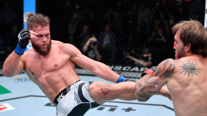 LAS VEGAS, NEVADA - DECEMBER 04: (L-R) Rafael Fiziev of Kyrgyzstan kicks Brad Riddell of New Zealand in their lightweight fight during the UFC Fight Night event at UFC APEX on December 04, 2021 in Las Vegas, Nevada. (Photo by Jeff Bottari/Zuffa LLC)