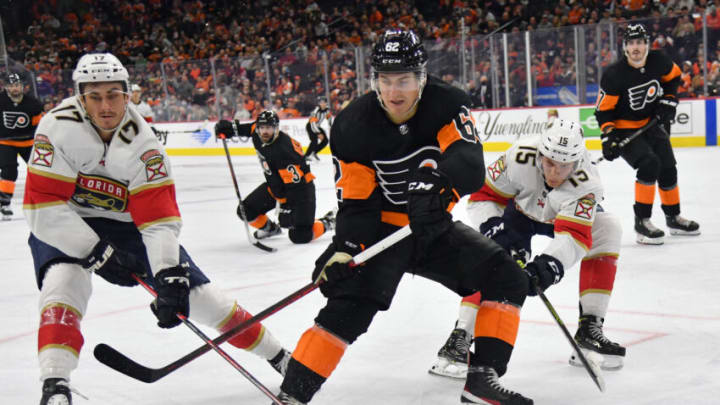 Oct 23, 2021; Philadelphia, Pennsylvania, USA; Philadelphia Flyers right wing Nicolas Aube-Kubel (62) battle for the puck against Florida Panthers left wing Mason Marchment (17) and center Anton Lundell (15) during the second period at Wells Fargo Center. Mandatory Credit: Eric Hartline-USA TODAY Sports