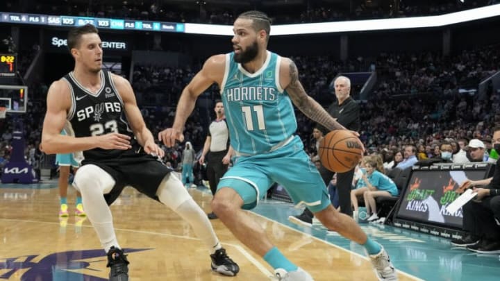 Mar 5, 2022; Charlotte, North Carolina, USA; Charlotte Hornets forward Cody Martin (11) drives to the basket against San Antonio Spurs forward Zach Collins (23) during the second half at the Spectrum Center. Mandatory Credit: Jim Dedmon-USA TODAY Sports