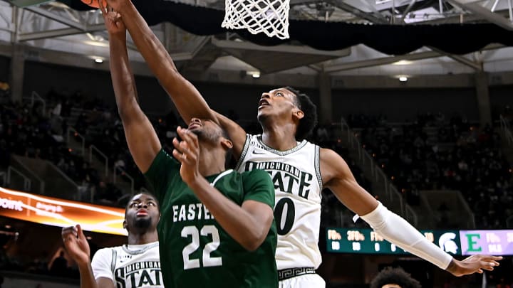Nov 20, 2021; East Lansing, Michigan, USA; Michigan State Spartans player Marcus Bingham Jr blocks a shot by Eastern Michigan Eagles player Yusuf Jihad (22) at Jack Breslin Student Events Center. Mandatory Credit: Dale Young-USA TODAY Sports