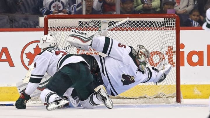 Sep 29, 2016; Winnipeg, Manitoba, CAN; Minnesota Wild goalie Darcy Kuemper (35) makes a save during the third period during a preseason hockey game against the Winnipeg Jets at MTS Centre. Winnipeg wins 4-1. Mandatory Credit: Bruce Fedyck-USA TODAY Sports