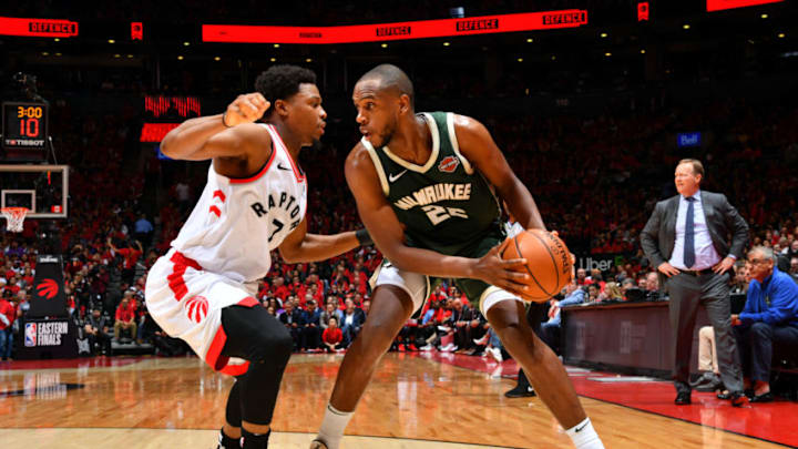 TORONTO, CANADA - MAY 21: Khris Middleton #22 of the Milwaukee Bucks handles the ball against Kyle Lowry #7 of the Toronto Raptors during Game Four of the Eastern Conference Finals of the 2019 NBA Playoffs on May 19, 2019 at the Scotiabank Arena in Toronto, Ontario, Canada. NOTE TO USER: User expressly acknowledges and agrees that, by downloading and or using this Photograph, user is consenting to the terms and conditions of the Getty Images License Agreement. Mandatory Copyright Notice: Copyright 2019 NBAE (Photo by Jesse D. Garrabrant/NBAE via Getty Images)