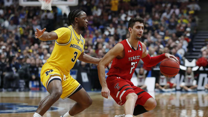 Davide Moretti #25 of the Texas Tech Red Raiders drives against Zavier Simpson #3 of the Michigan Wolverines (Photo by Sean M. Haffey/Getty Images)