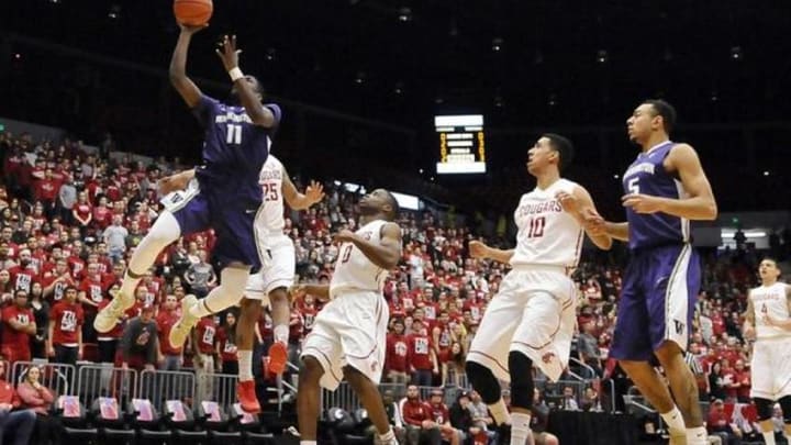 Feb 22, 2015; Pullman, WA, USA; Washington Huskies guard Mike Anderson (11) puts up a shot against Washington State Cougars guard DaVont Lacy (25) during the first half at Wallis Beasley Performing Arts Coliseum. Mandatory Credit: James Snook-USA TODAY Sports