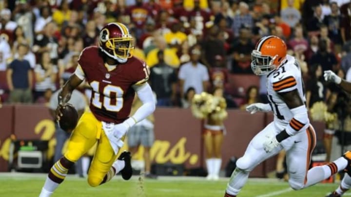 Aug 18, 2014; Landover, MD, USA; Washington Redskins quarterback Robert Griffin (10) rolls out as Cleveland Browns linebacker Barkevious Mingo (51) chases during the first half at FedEx Field. Mandatory Credit: Brad Mills-USA TODAY Sports