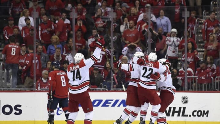 WASHINGTON, DC - APRIL 24: Brock McGinn #23 of the Carolina Hurricanes celebrates with his teammates after scoring the game winning goal in the second overtime period against the Washington Capitals in Game Seven of the Eastern Conference First Round during the 2019 NHL Stanley Cup Playoffs at Capital One Arena on April 24, 2019 in Washington, DC. The Hurricanes defeated the Capitals 4-3 in the second overtime period to move on to Round Two of the Stanley Cup playoffs. (Photo by Patrick McDermott/NHLI via Getty Images)