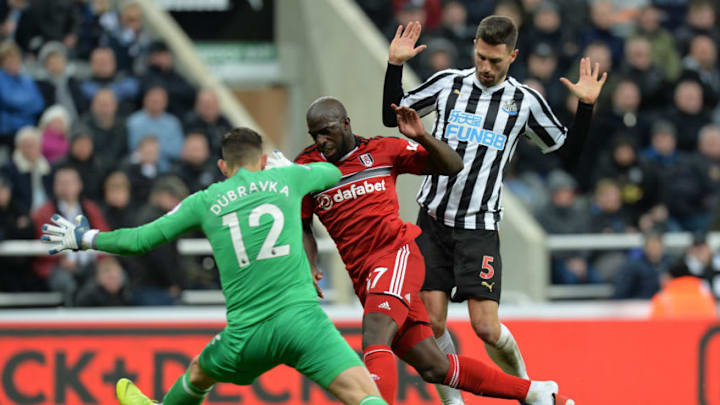 NEWCASTLE UPON TYNE, ENGLAND - DECEMBER 22: Aboubakar Kamara of Fulham is tackled by Fabian Schar and Martin Dubravka of Newcastle during the Premier League match between Newcastle United and Fulham FC at St. James Park on December 22, 2018 in Newcastle upon Tyne, United Kingdom. (Photo by Mark Runnacles/Getty Images)