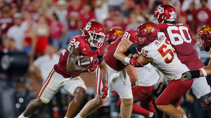 NORMAN, OKLAHOMA – SEPTEMBER 30: Running back Marcus Major #24 of the Oklahoma Sooners uses a block by tight end Austin Stogner #81 against defensive end Joey Petersen #52 of the Iowa State Cyclones to pick up a few yards in the fourth quarter at Gaylord Family Oklahoma Memorial Stadium on September 30, 2023 in Norman, Oklahoma. Oklahoma won 50-20. (Photo by Brian Bahr/Getty Images)