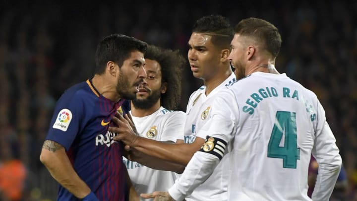 BARCELONA, SPAIN – MAY 06: Luis Suarez of Barcelona clashes with Sergio Ramos and Casemiro of Real Madrid during the La Liga match between Barcelona and Real Madrid at Camp Nou on May 6, 2018 in Barcelona, Spain. (Photo by Alex Caparros/Getty Images)