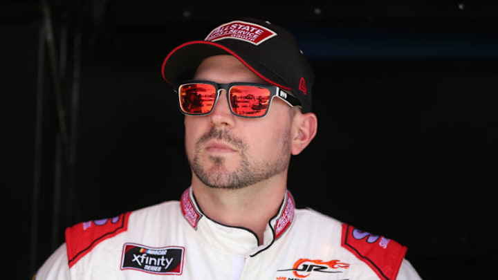 BROOKLYN, MICHIGAN - JUNE 07: Michael Annett, driver of the #1 AllState Parts and Service Group Chevrolet, stands in the garage area during practice for the NASCAR Xfinity Series LTi Printing 250 at Michigan International Speedway on June 07, 2019 in Brooklyn, Michigan. (Photo by Matt Sullivan/Getty Images)