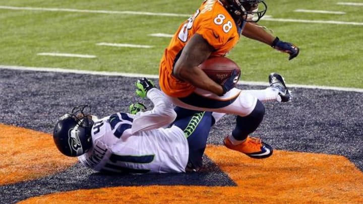 Feb 2, 2014; East Rutherford, NJ, USA; Denver Broncos wide receiver Demaryius Thomas (88) scores a touchdown against Seattle Seahawks cornerback Byron Maxwell (41) during the third quarter in Super Bowl XLVIII at MetLife Stadium. Mandatory Credit: Jim O