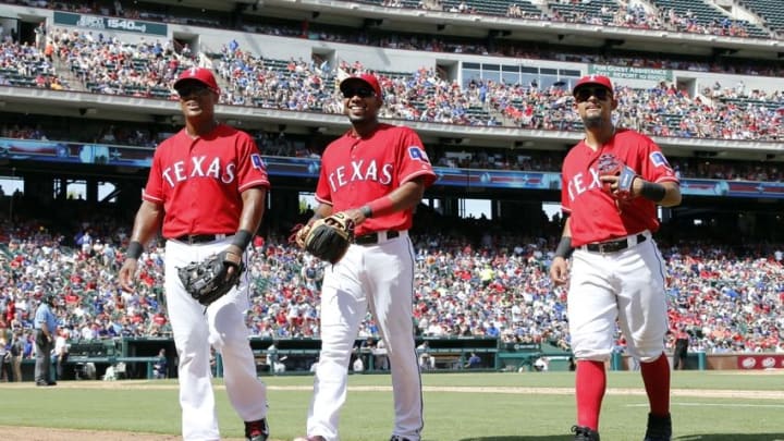 Jun 26, 2016; Arlington, TX, USA; Texas Rangers third baseman Adrian Beltre (29) and shortstop Elvis Andrus (1) and second baseman Rougned Odor (12) walk off the field in the sixth inning against the Boston Red Sox at Globe Life Park in Arlington. Texas won 6-2. Mandatory Credit: Tim Heitman-USA TODAY Sports