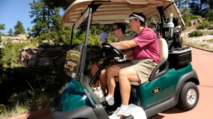 SEDALIA, CO--AUGUST 26TH 2010--Former Colorado Avalanche superstar, Joe Sakic, right, drives the golf-cart down a path with fellow golfer, John Bukowski, after hitting off of the #1 tee box to start the 13th Annual Joe Sakic Celebrity Classic golf tournament at the Sanctuary golf course in Sedalia Colorado, Thursday August 26th 2010. Sakic hosted fellow avalanche players and celebrities in the tournament, sponsored by RE/MAX and benefitting Food Bank of the Rockies' Children's programs. "Food Bank of the Rockies, is a non-profit organization, that has distributed nearly 36 million pounds of food last year through 800 partner agencies." "Since 1978, FBR has provided 392 million pounds of food to member agencies , which translates into more than 298 million meals for people in need." Andy Cross, The Denver Post (Photo By Andy Cross/The Denver Post via Getty Images)