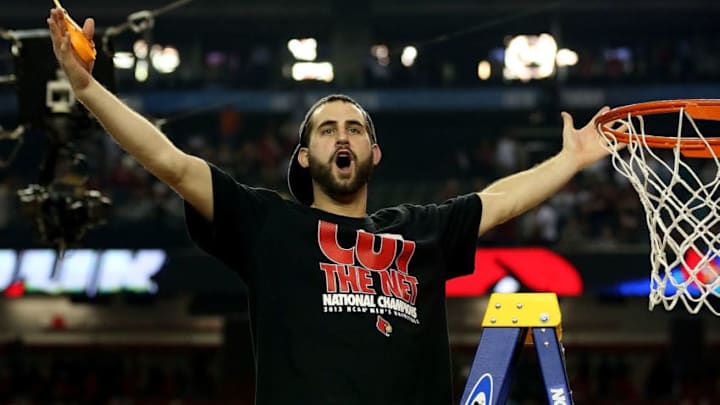 ATLANTA, GA - APRIL 08: Luke Hancock #11 of the Louisville Cardinals celebrates as he cuts down the net after they won 82-76 against the Michigan Wolverines during the 2013 NCAA Men's Final Four Championship at the Georgia Dome on April 8, 2013 in Atlanta, Georgia. (Photo by Streeter Lecka/Getty Images)