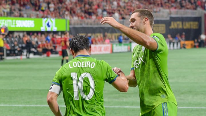 ATLANTA, GA JULY 15: Seattle's Nicolás Lodeiro (10) is congratulated by teammate Will Bruin (17) after scoring on a penalty kick during the match between Atlanta and Seattle on July 15th, 2018 at Mercedes-Benz Stadium in Atlanta, GA. Atlanta United FC and Seattle Sounders FC played to a 1 1 draw. (Photo by Rich von Biberstein/Icon Sportswire via Getty Images)