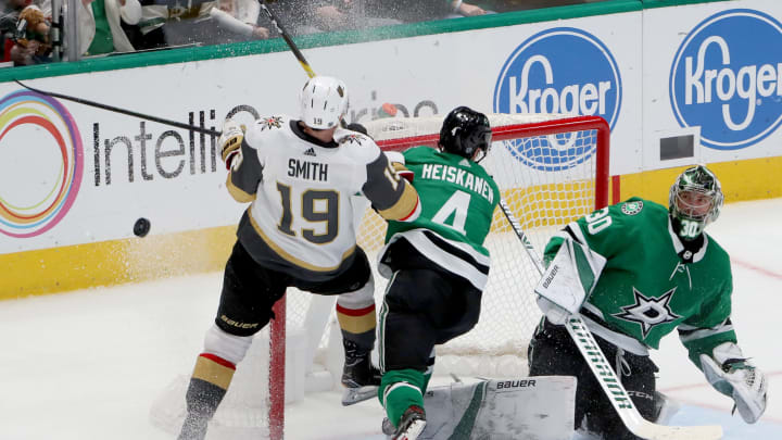 DALLAS, TEXAS – DECEMBER 13: Ben Bishop #30 of the Dallas Stars blocks a shot on goal as Miro Heiskanen #4 of the Dallas Stars collides with Reilly Smith #19 of the Vegas Golden Knights in the first overtime period at American Airlines Center on December 13, 2019 in Dallas, Texas. (Photo by Tom Pennington/Getty Images)