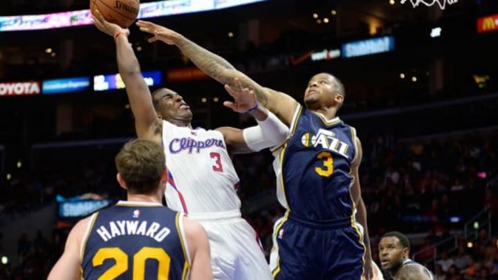 Nov 3, 2014; Los Angeles, CA, USA; Los Angeles Clippers guard Chris Paul (3) drives to the basket as Utah Jazz guard Trey Burke (3) defends during the second half at Staples Center. Mandatory Credit: Richard Mackson-USA TODAY Sports