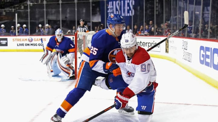 NEW YORK, NEW YORK - MARCH 03: Tomas Tatar #90 of the Montreal Canadiens is checked by Devon Toews #25 of the New York Islanders during the first period at the Barclays Center on March 03, 2020 in the Brooklyn borough of New York City. (Photo by Bruce Bennett/Getty Images)