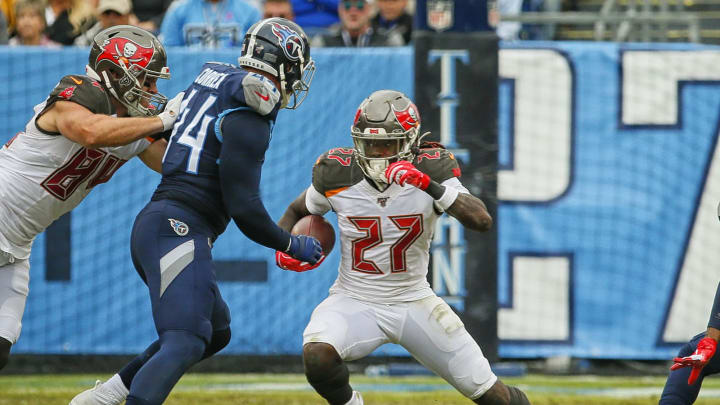 NASHVILLE, TENNESSEE – OCTOBER 27: Ronald Jones #27 of the Tampa Bay Buccaneers carries the ball against Kamalei Correa #44 of the Tennessee Titans during the second half at Nissan Stadium on October 27, 2019 in Nashville, Tennessee. (Photo by Frederick Breedon/Getty Images)