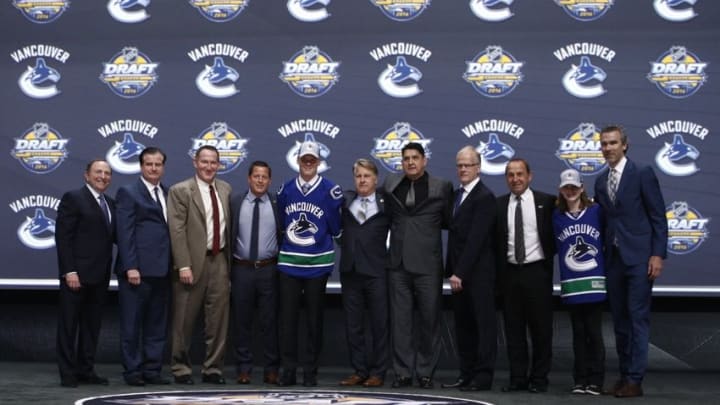 Jun 24, 2016; Buffalo, NY, USA; Olli Juolevi poses for a photo after being selected as the number five overall draft pick by the Vancouver Canucks in the first round of the 2016 NHL Draft at the First Niagra Center. Mandatory Credit: Timothy T. Ludwig-USA TODAY Sports