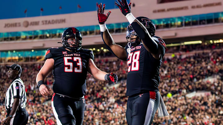 LUBBOCK, TEXAS – OCTOBER 14: Tahj Brooks #28 of the Texas Tech Red Raiders celebrates with Rusty Staats #53 after scoring a touchdown during the first half of the game against the Kansas State Wildcats at Jones AT&T Stadium on October 14, 2023 in Lubbock, Texas. (Photo by John E. Moore III/Getty Images)