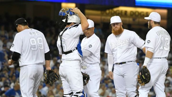 LOS ANGELES, CA - AUGUST 23: Hyun-Jin Ryu #99 of the Los Angeles Dodgers is taken out from the game after giving up a grand slam to Didi Gregorius #18 of the New York Yankees in the fifth inning at Dodger Stadium on August 23, 2019 in Los Angeles, California. Teams are wearing special color schemed uniforms with players choosing nicknames to display for Players' Weekend. (Photo by John McCoy/Getty Images)