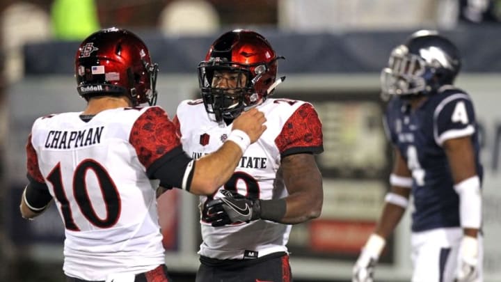 Nov 12, 2016; Reno, NV, USA; San Diego State quarterback Christian Chapman (10) greets running back Jawan Washington (29) after his fourth quarter touchdown against the Nevada Wolf Pack at MacKay Stadium. Mandatory Credit: Lance Iversen-USA TODAY Sports