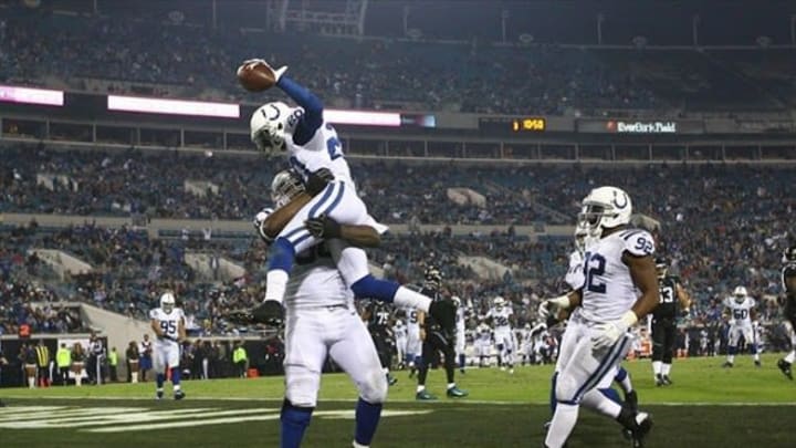 Nov 8, 2012; Jacksonville FL, USA; Indianapolis Colts defensive end Cory Redding (90) lifts defensive back Darius Butler (20) after returning an interception for a touchdown during the third quarter at EverBank Field. Indianapolis defeated Jacksonville 27-10. Mandatory Credit: Douglas Jones-USA TODAY Sports