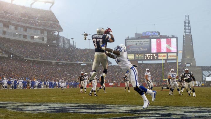 FOXBORO, MA - JANUARY 18: Safety Rodney Harrison #37 of the New England Patriots intercepts the ball in front of tight end Marcus Pollard #81 of the Indianapolis Colts in the AFC Championship Game on January 18, 2004 at Gillette Stadium in Foxboro, Massachusetts. (Photo by Ezra Shaw/Getty Images)