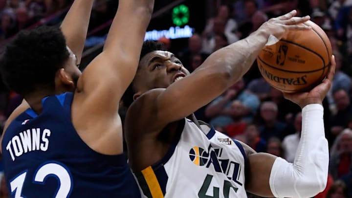 SALT LAKE CITY, UT - JANUARY 25: Donovan Mitchell #45 of the Utah Jazz goes to the basket past Karl-Anthony Towns #32 of the Minnesota Timberwolves in the second half of a NBA game at Vivint Smart Home Arena on January 25, 2019 in Salt Lake City, Utah. (Photo by Gene Sweeney Jr./Getty Images)