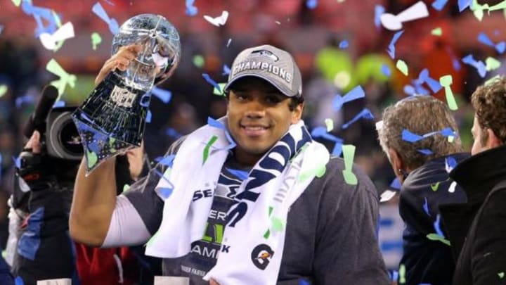 Feb 2, 2014; East Rutherford, NJ, USA; Seattle Seahawks quarterback Russell Wilson (3) celebrates with the Lombardi Trophy after beating the Denver Broncos 43-8 in Super Bowl XLVIII at MetLife Stadium. Mandatory Credit: Brad Penner-USA TODAY Sports