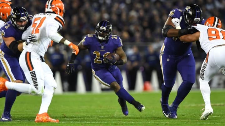 Nov 10, 2016; Baltimore, MD, USA; Baltimore Ravens running back Terrance West (28) runs as Cleveland Browns outside linebacker Jamie Collins (51) closing the gap during the first quarter at M&T Bank Stadium. Mandatory Credit: Tommy Gilligan-USA TODAY Sports