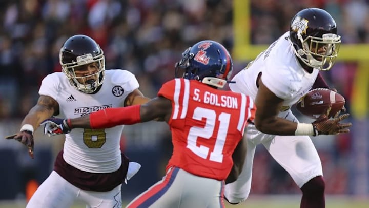 Nov 29, 2014; Oxford, MS, USA; Mississippi State Bulldogs tight end Malcolm Johnson (6) carries the ball as defends Mississippi Rebels defensive back Senquez Golson (21) at Vaught-Hemingway Stadium. The Rebels won 31-17. Mandatory Credit: Spruce Derden-USA TODAY Sports