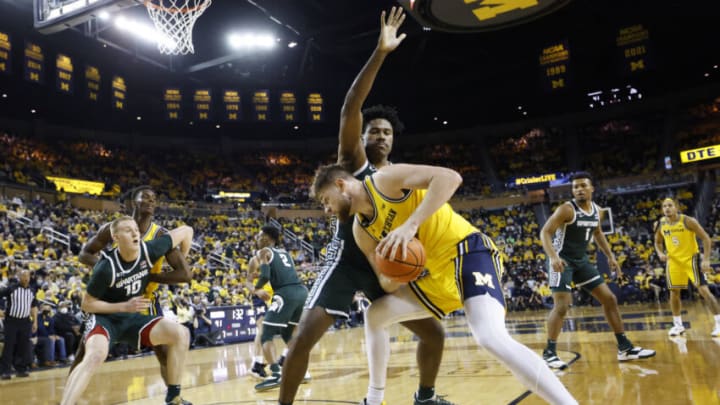 Mar 1, 2022; Ann Arbor, Michigan, USA; aMichigan Wolverines center Hunter Dickinson (1) is defended by Michigan State Spartans forward Julius Marble II (34) in the first half t Crisler Center. Mandatory Credit: Rick Osentoski-USA TODAY Sports
