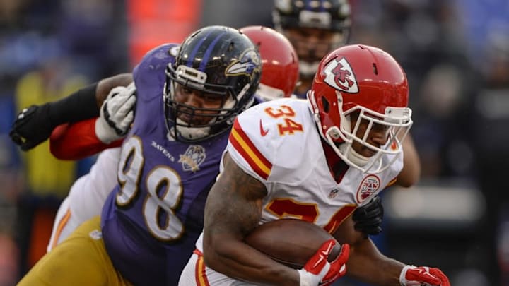 Dec 20, 2015; Baltimore, MD, USA; Kansas City Chiefs running back Knile Davis (34) runs through Baltimore Ravens nose tackle Brandon Williams (98) tackle attempt at M&T Bank Stadium. Kansas City defeated Baltimore 34-14. Mandatory Credit: Tommy Gilligan-USA TODAY Sports