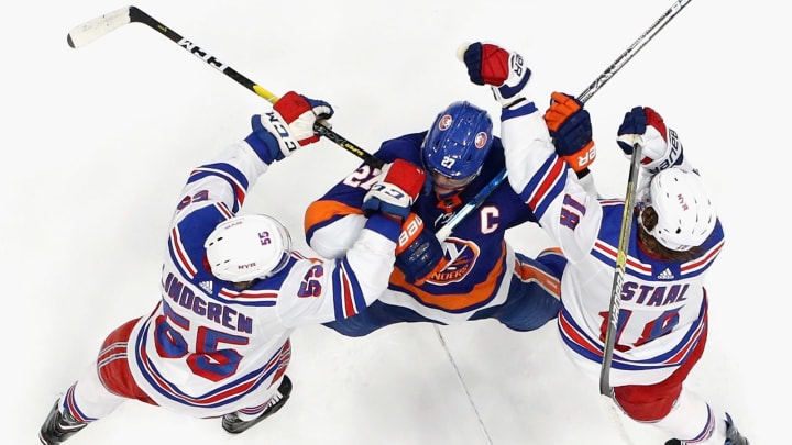 Ryan Lindgren and Marc Staal of the New York Rangers defend against Anders Lee of the New York Islanders during the third period at NYCB Live’s Nassau Coliseum on January 16, 2020 in Uniondale, New York.