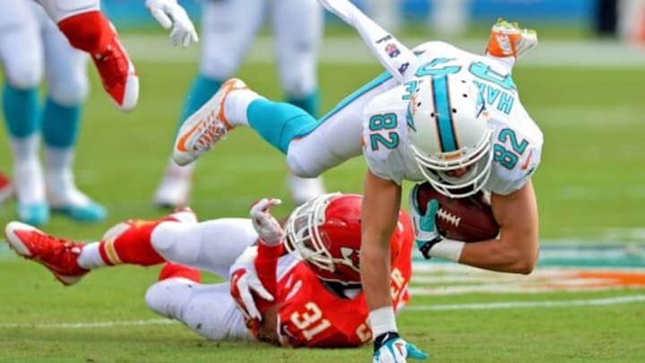 Sep 21, 2014; Miami Gardens, FL, USA; Miami Dolphins wide receiver Brian Hartline (82) is tripped by Kansas City Chiefs cornerback Marcus Cooper (31) during the first half at Sun Life Stadium. Mandatory Credit: Steve Mitchell-USA TODAY Sports