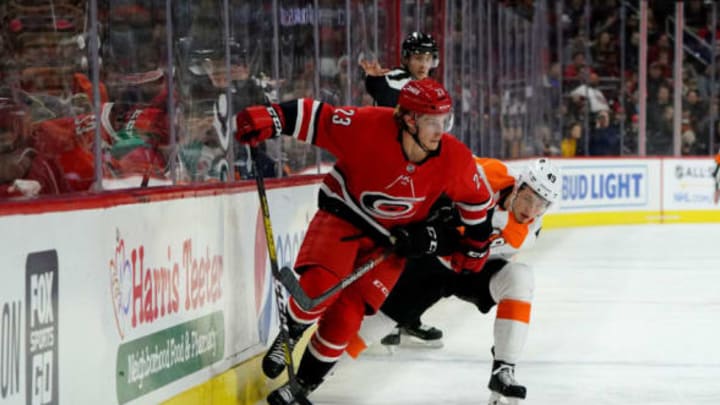 RALEIGH, NC – JANUARY 7: Brock McGinn #23 of the Carolina Hurricanes moves the puck along the boards and battles with Joel Farabee #49 of the Philadelphia Flyers during an NHL game on January 7, 2020 at PNC Arena in Raleigh, North Carolina. (Photo by Gregg Forwerck/NHLI via Getty Images)