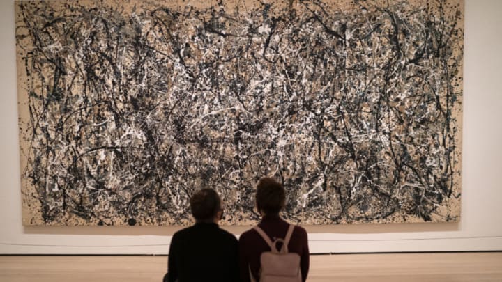 NEW YORK, NY - DECEMBER 30: Viewers look at an abstract expressionist painting by artist Jackson Pollock titled "One: Number 31, 1950" on December 30, 2020 at the Museum of Modern Art in New York City. Museum of Modern Art goers must now reserve their entrance tickets on-line for a specific day. (Photo by Robert Nickelsberg/Getty Images)