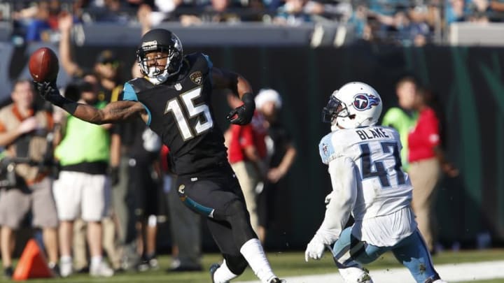 Dec 24, 2016; Jacksonville, FL, USA; Jacksonville Jaguars wide receiver Allen Robinson (15) makes a one handed catch as Tennessee Titans defensive back Valentino Blake (47) defends during the second half of an NFL football game at EverBank Field.The Jaguars won 38-17. Mandatory Credit: Reinhold Matay-USA TODAY Sports