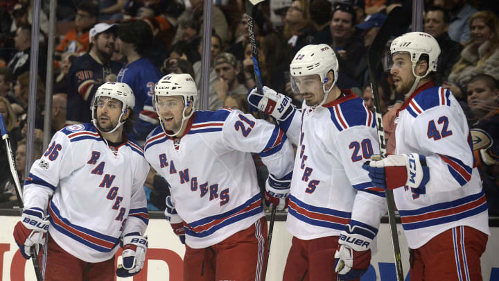 March 26, 2017; Anaheim, CA, USA; New York Rangers center Derek Stepan (21) celebrates with right wing Mats Zuccarello (36), left wing Chris Kreider (20) and defenseman Brendan Smith (42) his goal scored against the Anaheim Ducks during the first period at Honda Center. Mandatory Credit: Gary A. Vasquez-USA TODAY Sports