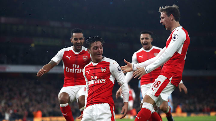 LONDON, ENGLAND – DECEMBER 10: Mesut Ozil of Arsenal (C) celebrates scoring his sides second goal with his Arsenal team mates during the Premier League match between Arsenal and Stoke City at the Emirates Stadium on December 10, 2016 in London, England. (Photo by Julian Finney/Getty Images)