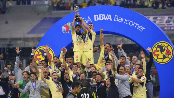 MEXICO CITY, MEXICO - DECEMBER 16: Oribe Peralta #24 and Paul Aguilar #22 of America lift the Championship Trophy after the final second leg match between Cruz Azul and America as part of the Torneo Apertura 2018 Liga MX at Azteca Stadium on December 16, 2018 in Mexico City, Mexico. (Photo by Jaime Lopez/Jam Media/Getty Images)"n