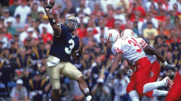 9 Sep 2000: Arnaz Battle #3 of the Notre Dame Fighting Irish tosses the ball before getting tackled by Randy Stella #34 of the Nebraska Cornhuskers during the game at the Notre Dame Stadium in South Bend, Indiana. The Cornhuskers defeated the Fighting Irish 27-24Mandatory Credit: Jonathan Daniel /Allsport