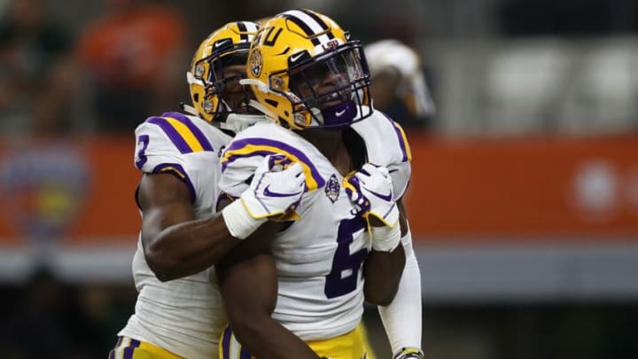 ARLINGTON, TX - SEPTEMBER 02: Jacob Phillips #6 of the LSU Tigers celebrates with JaCoby Stevens #3 after scoring a touchdown on a pass interception against the Miami Hurricanes in the second quarter during the AdvoCare Classic at AT&T Stadium on September 2, 2018 in Arlington, Texas. (Photo by Ronald Martinez/Getty Images)
