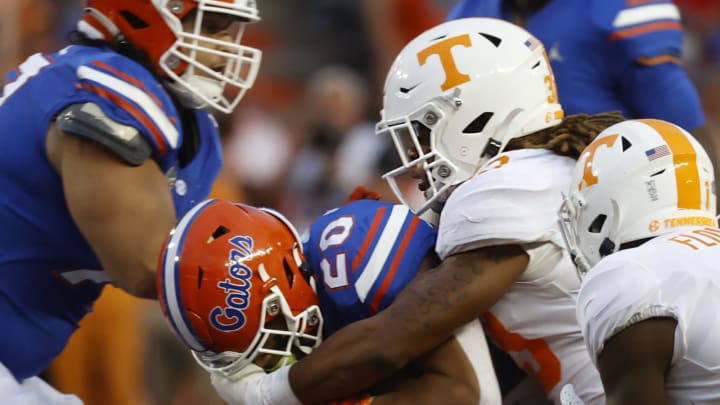 Sep 25, 2021; Gainesville, Florida, USA; Florida Gators running back Malik Davis (20) runs with the ball as Tennessee Volunteers linebacker Jeremy Banks (33) tackles during the first quarter at Ben Hill Griffin Stadium. Mandatory Credit: Kim Klement-USA TODAY Sports