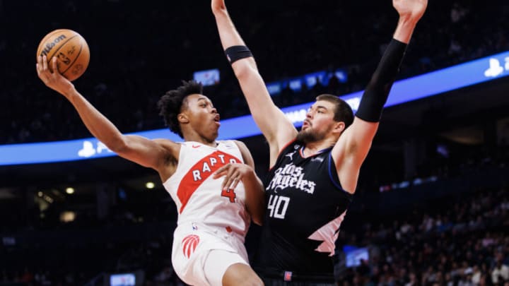 TORONTO, ON - DECEMBER 27: Scottie Barnes #4 of the Toronto Raptors puts up a shot over Ivica Zubac #40 of the LA Clippers (Photo by Cole Burston/Getty Images)