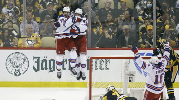 May 13, 2022; Pittsburgh, Pennsylvania, USA; New York Rangers left wing Chris Kreider (20) and center Mika Zibanejad (93) celebrate a goal by Kreider against Pittsburgh Penguins goaltender Louis Domingue (70) during the second period in game six of the first round of the 2022 Stanley Cup Playoffs at PPG Paints Arena. Mandatory Credit: Charles LeClaire-USA TODAY Sports