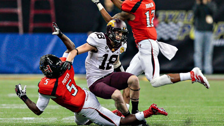 Tre’ Porter #5 of the Texas Tech Red Raiders breaks up a pass intended for Derrick Engel #18 of the Minnesota Golden Gophers as D.J. Johnson #12 of the Texas Tech Red Raiders comes in for the interception (Photo by Bob Levey/Getty Images)