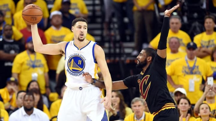 Jun 19, 2016; Oakland, CA, USA; Golden State Warriors guard Klay Thompson (11) handles the ball against Cleveland Cavaliers guard Kyrie Irving (2) during the first quarter in game seven of the NBA Finals at Oracle Arena. Mandatory Credit: Bob Donnan-USA TODAY Sports